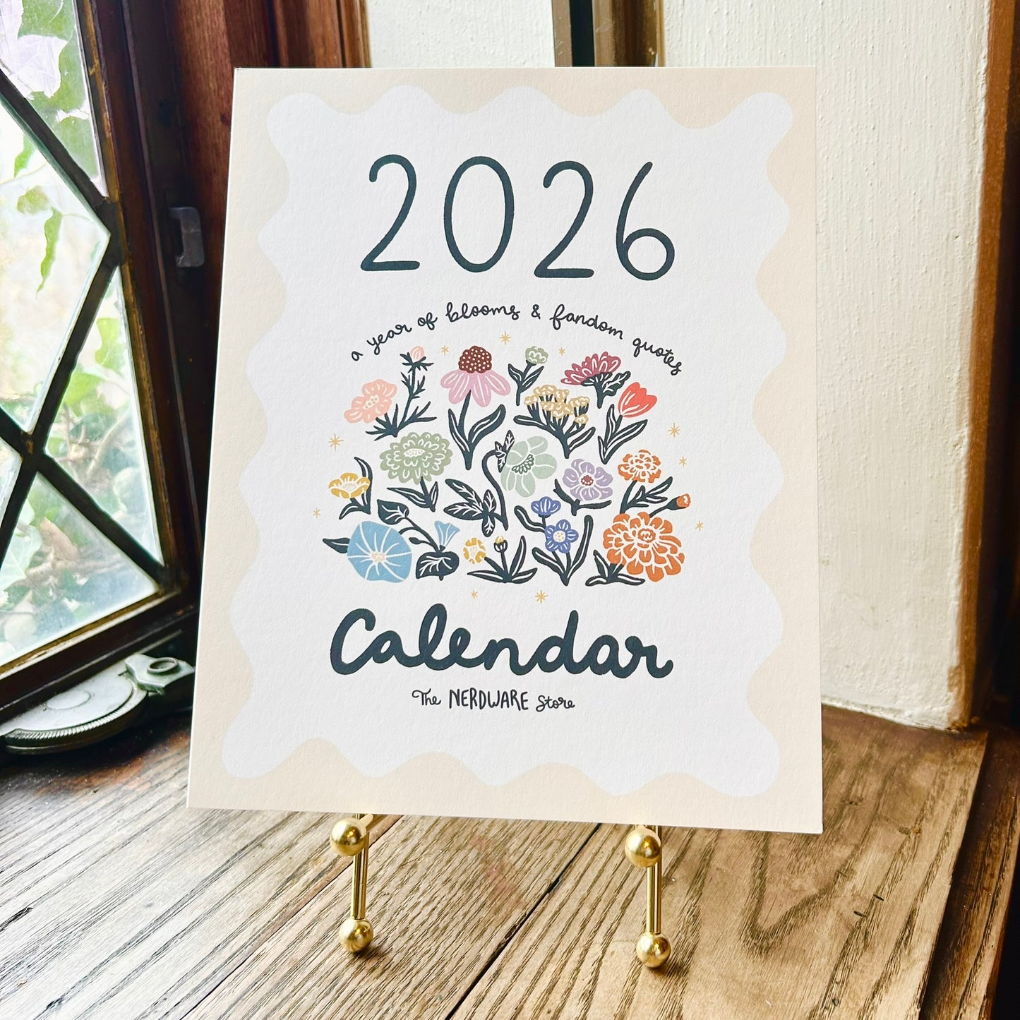 Calendar for 2026 with floral design on a wooden surface