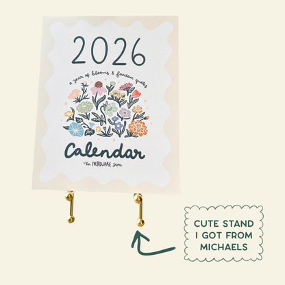 Calendar with floral design and '2026' text, featuring a cute stand from Michaels on a beige background.